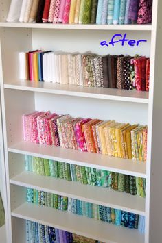 a white book shelf filled with lots of different colored fabrics