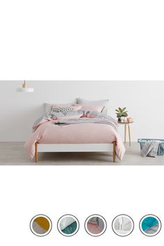 an image of a bedroom setting with bed linens and pillows in pastel colors