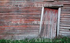 an old red barn with a wooden door