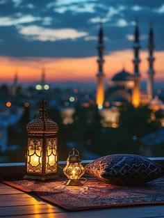 a lantern and pillow on top of a wooden table in front of a view of the city