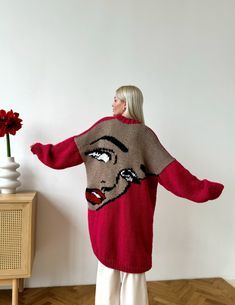 This unique pop-art style knitted cardigan is fully handmade of high quality wool blend yarn. The picture on the back is embroidered by hands. This cardigan can be customised. You can choose the colours you prefer. Trendy Handmade Knit Cardigan, Handmade Sweater Coat, Handmade Oversized Trendy Cardigan, Handmade One-size Sweater, Handmade One Size Acrylic Cardigan, Handmade One-size Acrylic Cardigan, Handmade Oversized Sweater, Handmade Oversized Sweater Coat, Red Knitted Cardigan