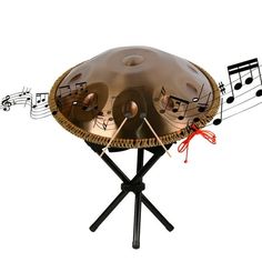 a musical instrument on top of a table with musical notes around it and sticks sticking out of the middle