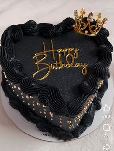 a heart shaped birthday cake with the words happy birthday written in gold letters on it