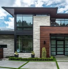 a modern house with large windows and landscaping