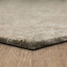 a close up view of an area rug on a wooden floor that looks like it has been made out of wool