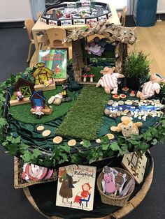 a table with many different items on it in the shape of a house and garden