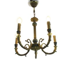 a chandelier with five lights hanging from it's center and four arms