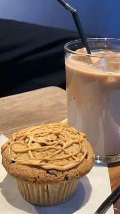 a cup of coffee and a cookie on a table