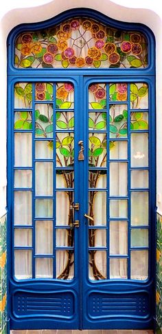 two blue doors with stained glass windows on them