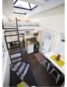 a loft bed is built into the side of a small house with stairs leading up to it