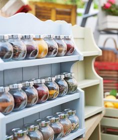 there are many jars on the shelves in this store and one is filled with spices