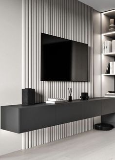 an entertainment center with a flat screen tv mounted on the wall and bookshelves