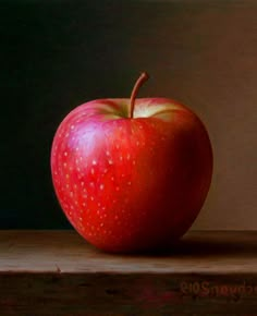 an apple sitting on top of a wooden table