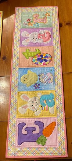 a child's play mat on the floor with an animal and letters design in it