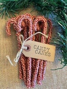 candy canes are wrapped in red and white checkered fabric with a brown tag