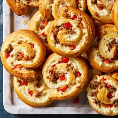 there are many different types of pastries on the tray together and one is filled with meat