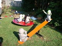 two children's toys sit on top of seesaws in the yard