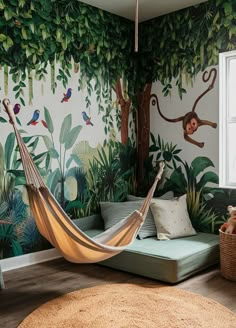 a living room with a hammock in the middle of it and monkeys on the wall