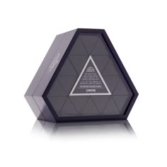 a black and silver pyramid shaped object on a white surface with the wording below it