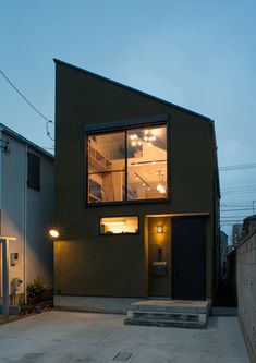 a modern house with an open floor plan and large windows on the front of it