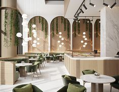 the interior of a restaurant with green chairs and tables