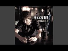 a man sitting at a table with a bottle in front of him and the words, eric church shine's live me