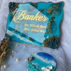 there is a glass plate with the words banks on it next to some seashells