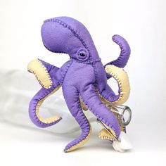 an octopus stuffed animal holding a pair of scissors