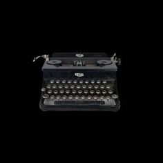 an old - fashioned typewriter is shown against a black background in this image, it appears to be empty