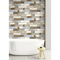 a bath tub sitting next to a wall with wooden planks on the walls behind it