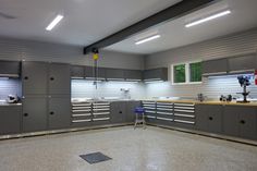 a garage with lots of cabinets and tools