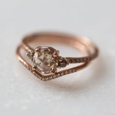 a close up of a ring on a white surface with some diamonds in the middle