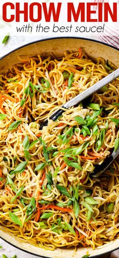 a skillet filled with chow mein noodles, carrots and green onions in it