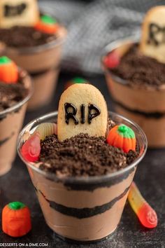 halloween desserts in plastic cups decorated with chocolate and candy