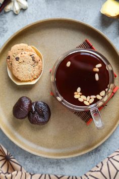 a cup of coffee and some cookies on a plate