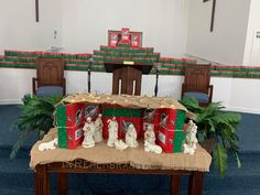 a table with some decorations on it in the middle of a room filled with chairs