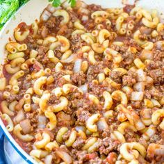 a skillet filled with macaroni and cheese on top of a blue towel