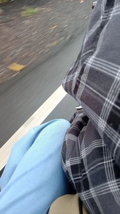 the back end of a person's head as they ride on a motorcycle down a road