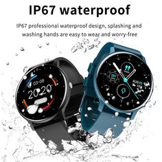 two smart watches sitting next to each other with water droplets on the ground behind them