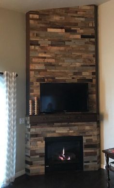 a living room with a fireplace and flat screen tv mounted on the wall above it