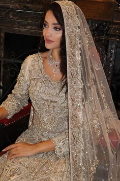 a woman in a wedding dress sitting down