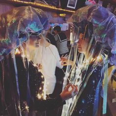 two women dressed up in costumes standing next to each other with lights on their head