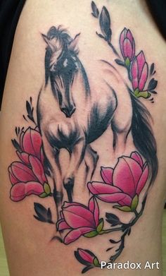 a horse and flowers tattoo on the back of a woman's thigh, with pink flowers around it