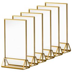 four mirrors are lined up in a row on a white background, one is gold and the other is clear