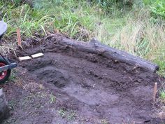 a wheelbarrow is sitting in the middle of some dirt