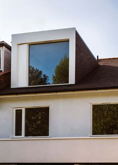 an image of a house with windows on the top and bottom floor that are open