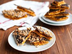 several pieces of chocolate and peanut butter bars on plates