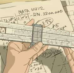 a person holding a ruler in their hand over some paper with numbers on it and other papers behind them