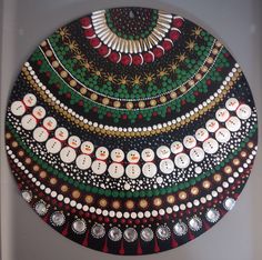 a decorative plate with many different designs and colors on the top, along with buttons