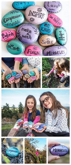 two girls holding rocks with words written on them